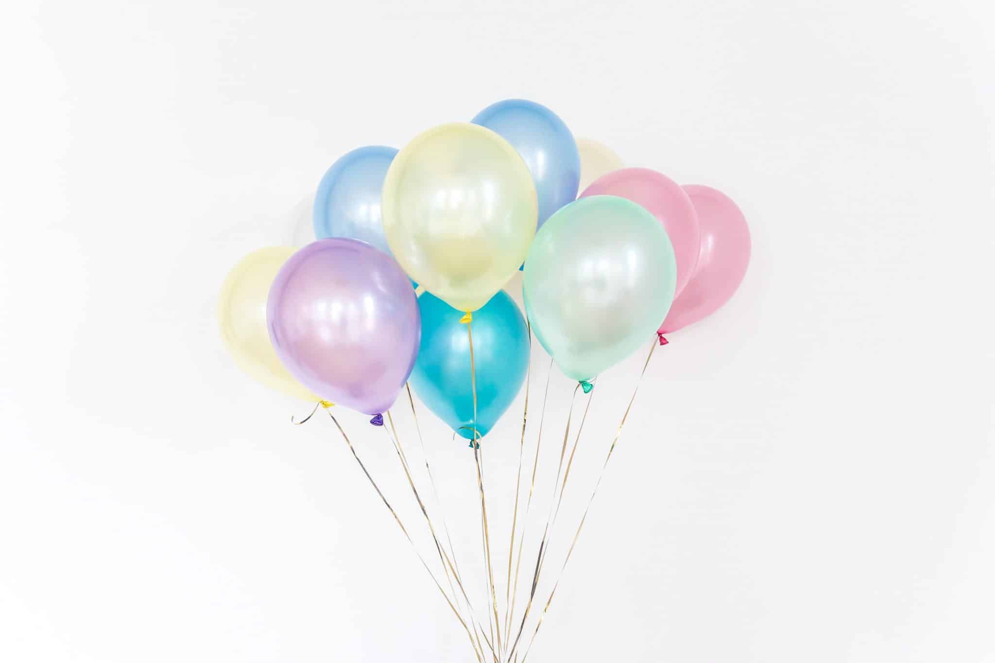 Colorful balloons against a white background.