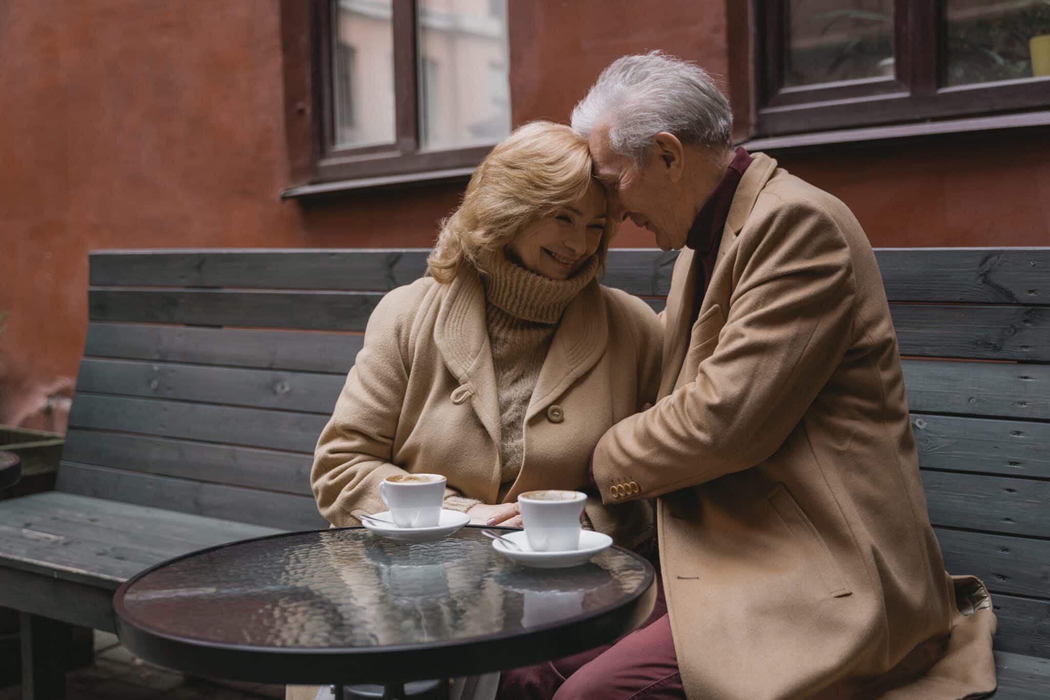 Older couple enjoying a coffee date outside.