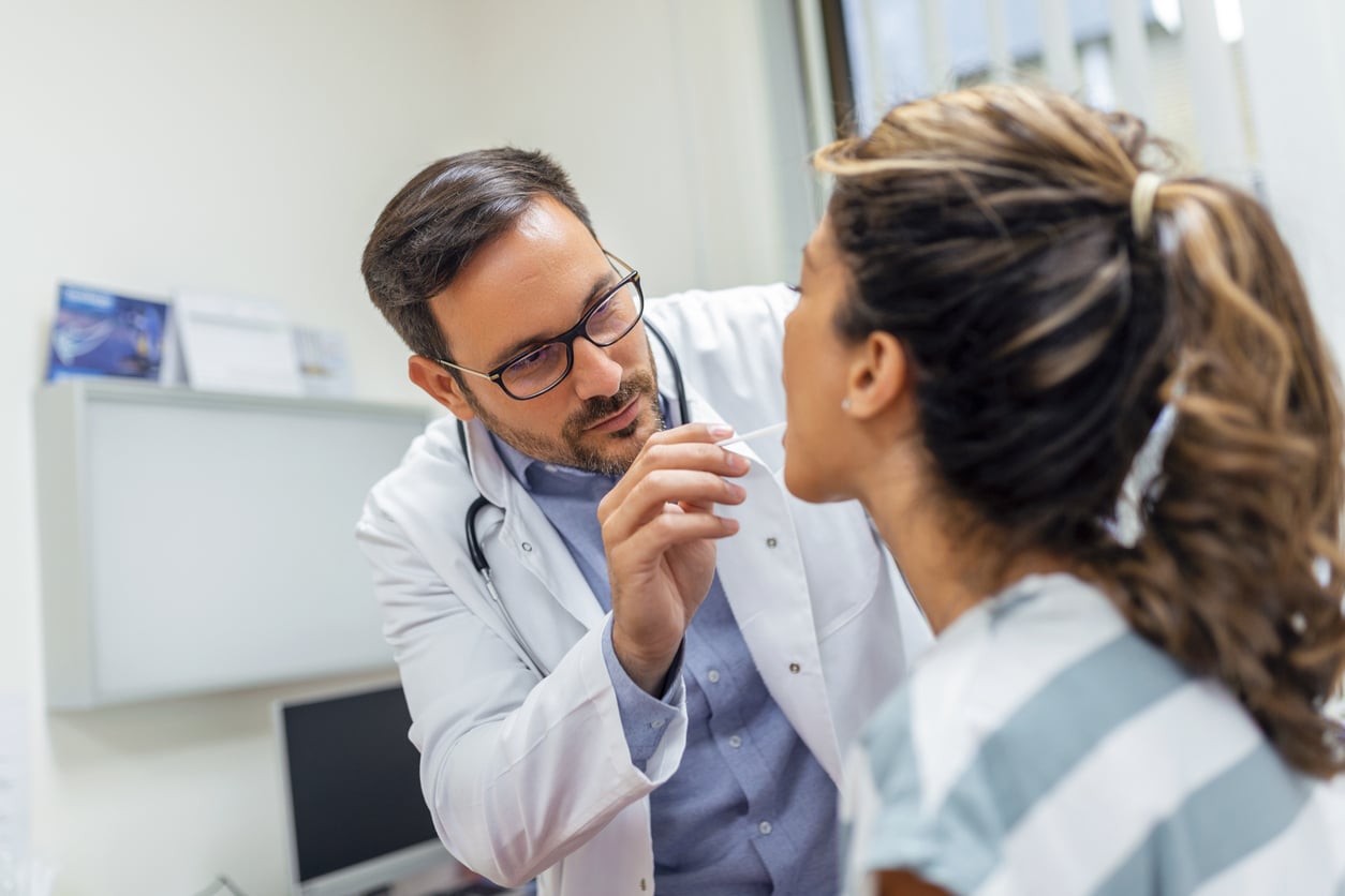 ENT doctor testing a patient for strep throat