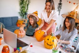 Family decorating pumpkins together for halloween