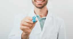 Audiologist holding up a custom earplug