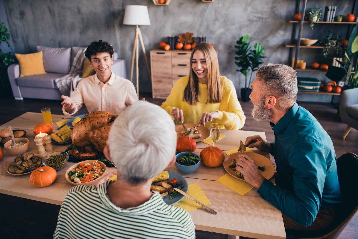 Happy family having a small Thanksgiving dinner.