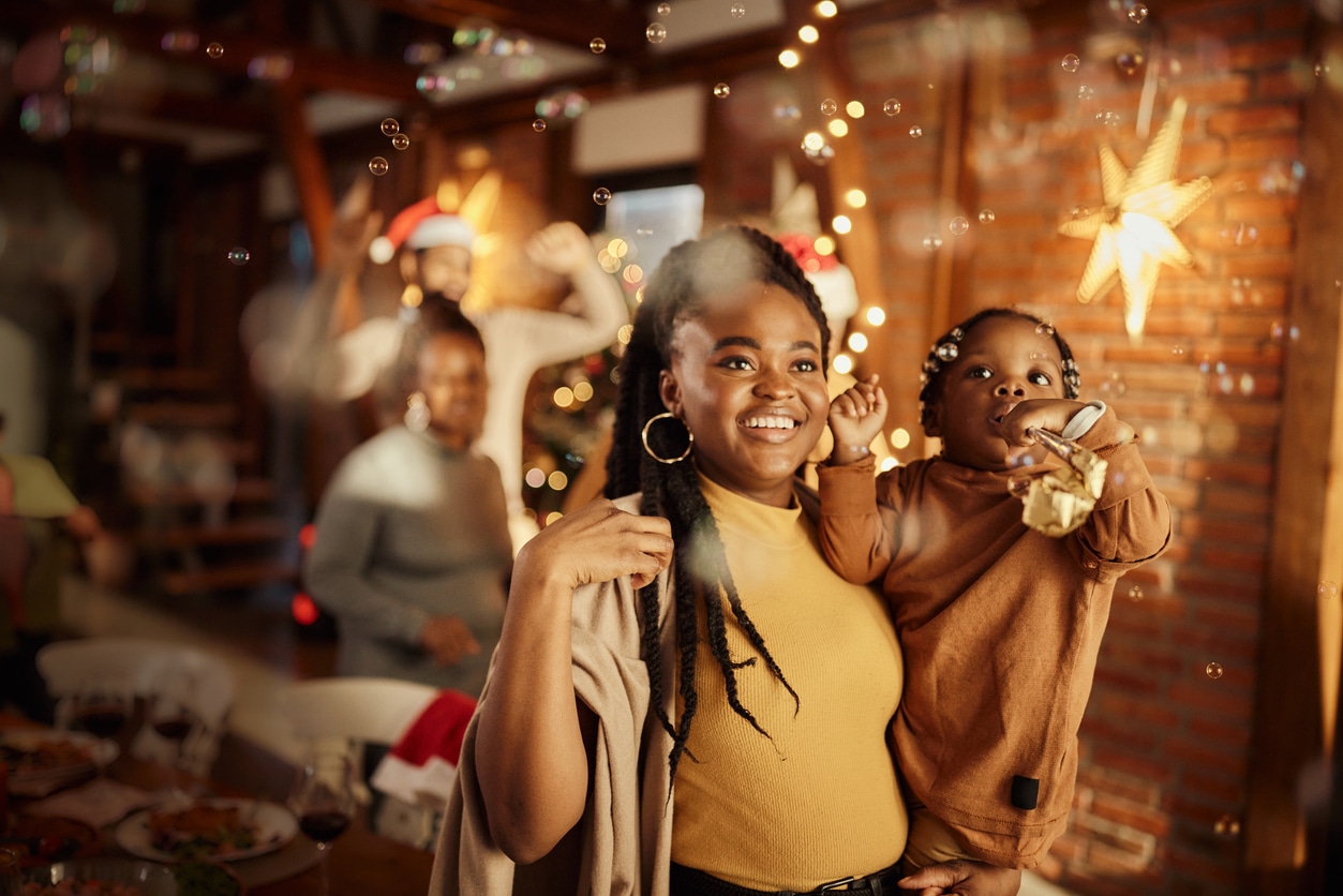 Mom and her daughter looking at the decorations at a holiday party.